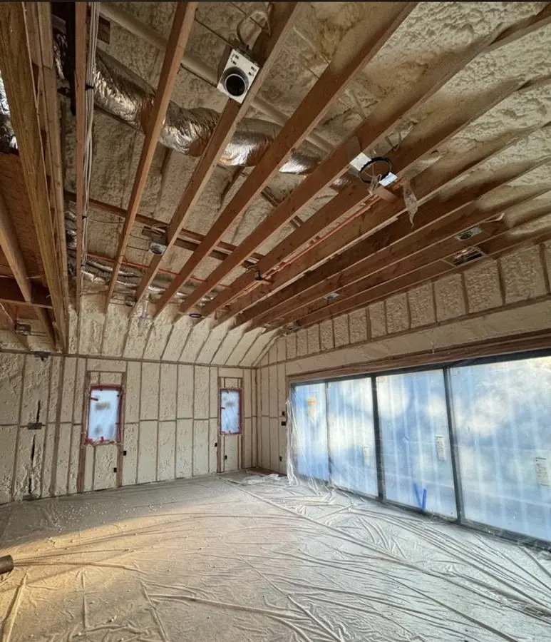 Interior walls and ceiling insulated with spray foam during new construction in Itasca